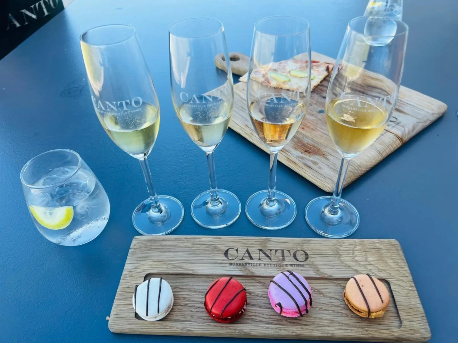 Four glasses of sparkling wine with a macaron pairing board