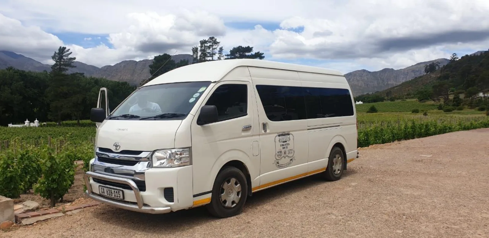 The tour minibus parked beside the vineyards at a Stellenbosch estate